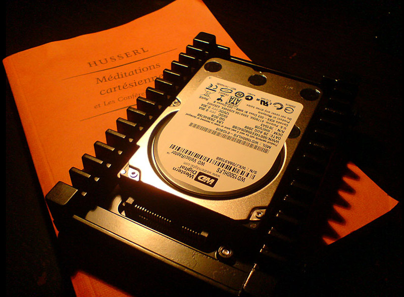 photo of a computer hard drive on a book of philosophy